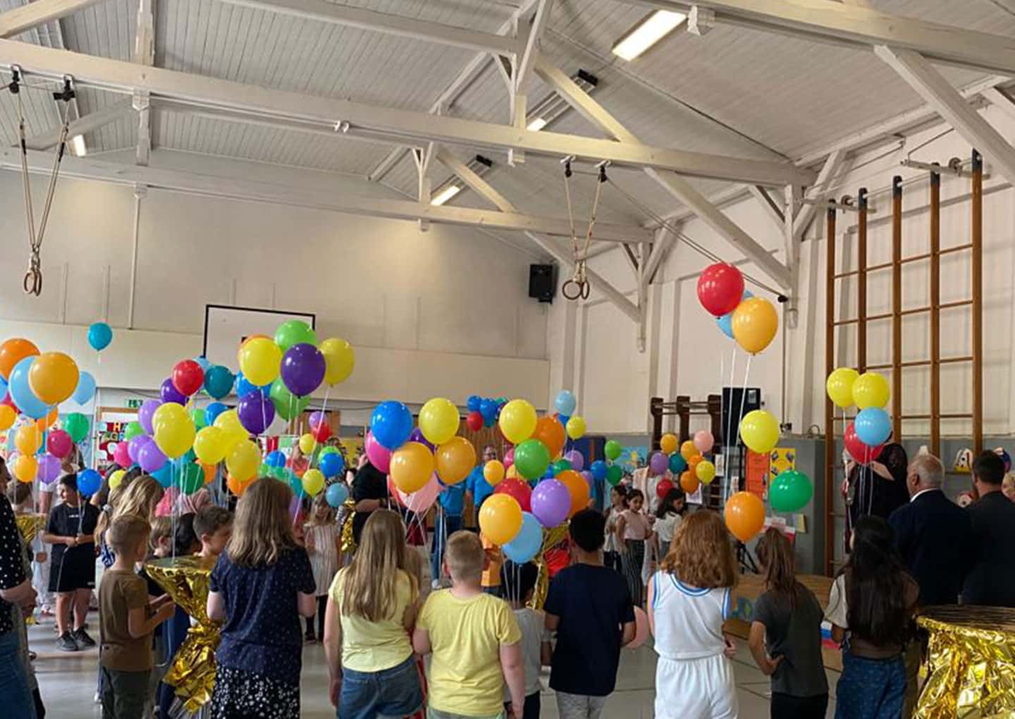 Leute stehen in der geschmückten Sporthalle